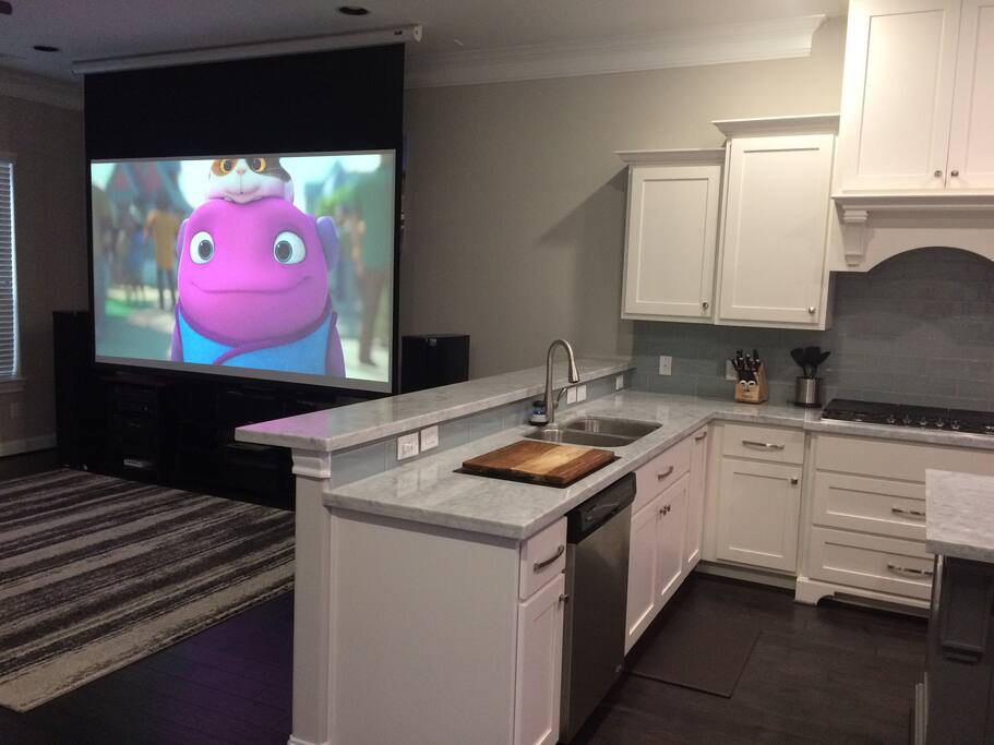 View into living room with 120" drop down projection screen.