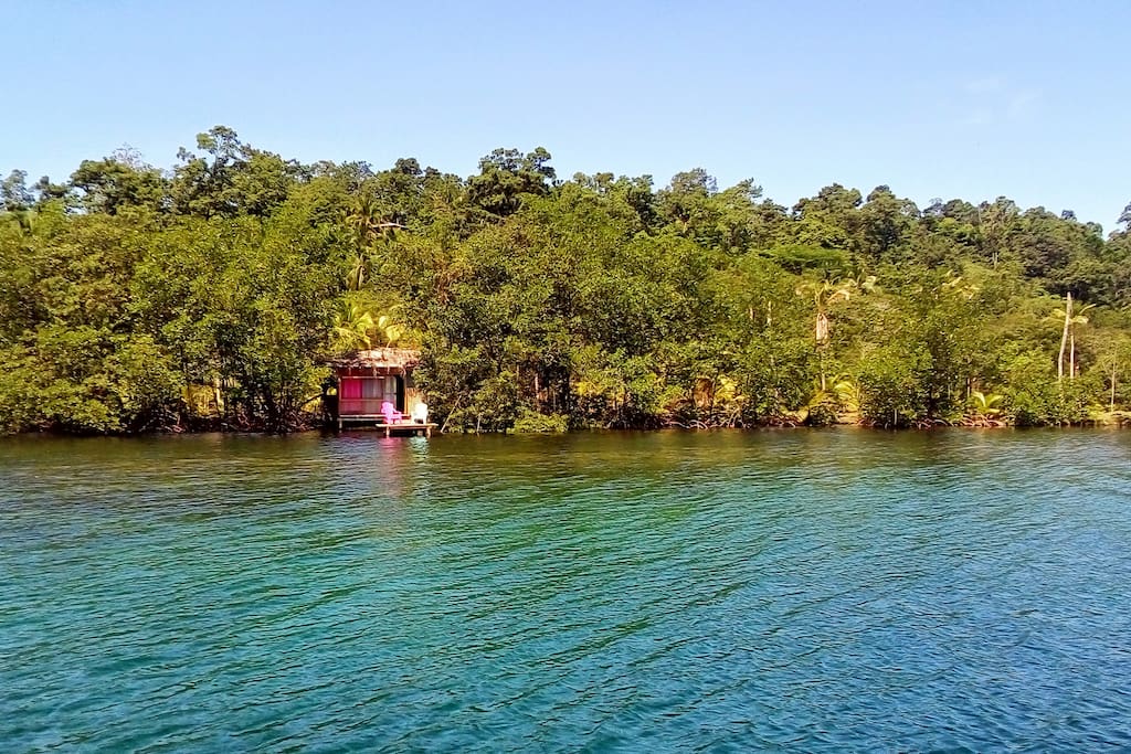 The Hidden Treasure Cabin sits on stilts over a turquoise lagoon, a beautiful reef at your doorstep.