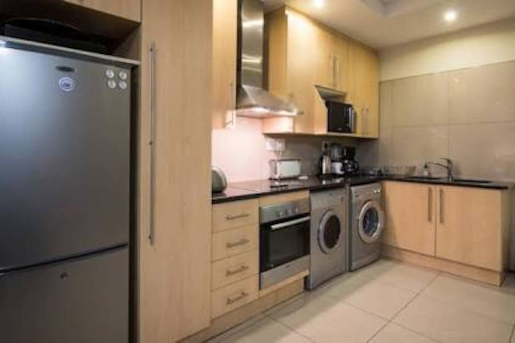 Kitchen: equipped with fridge & freezer, oven, stove top and hub. Dryer and washer,double wash up basin, and lots of counter space, cupboards and appliances : kettle, toaster etc