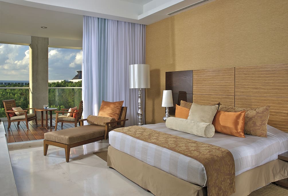 Master Suite with Lounge Recline chair with view to the Balcony that has coffee table with the dipping pool