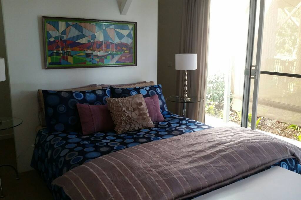 Master bedroom with private courtyard garden and deck outside.