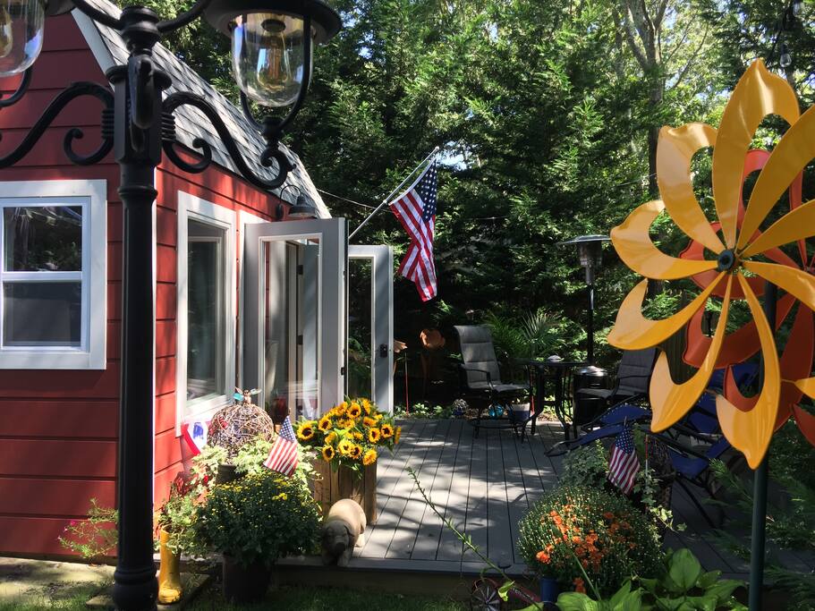 Love the view from this angle. French doors open. Potted plants with lighted orbs welcome you in the evening and create a romantic mood. As well as torches around the deck lit in the evening.
