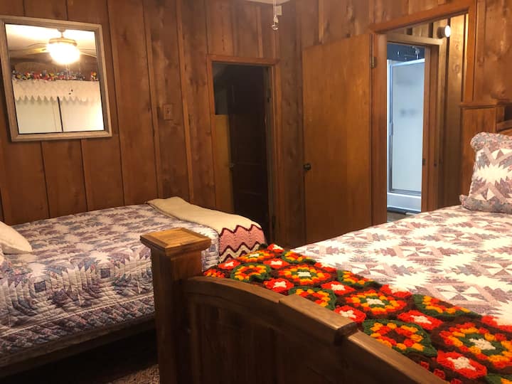 Main bedroom with a queen and a full size bed offering families a fun and enjoyable space. Enjoy East Texas activities and discover a refreshing shower and clean, comfy beds after an exciting day of sightseeing. Don't forget those fresh farm eggs! 