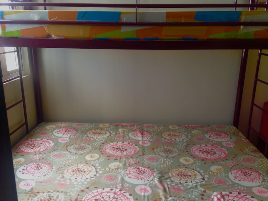 Double deck bed. Double-sized bed below and single-sized bed on top