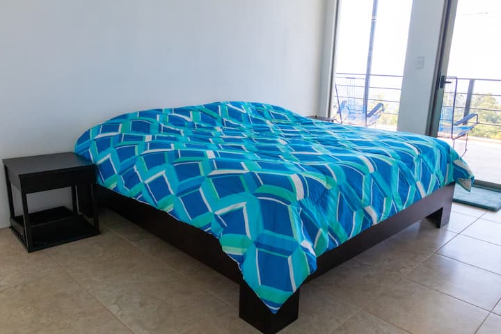 Second spacious bedroom, also with a king sized bed. This bedroom overlooks the balcony with mountain and valley views.