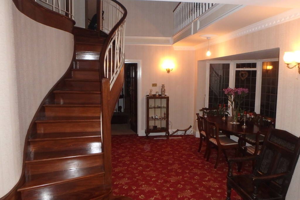 Dining hall with unique mahogany staircase.