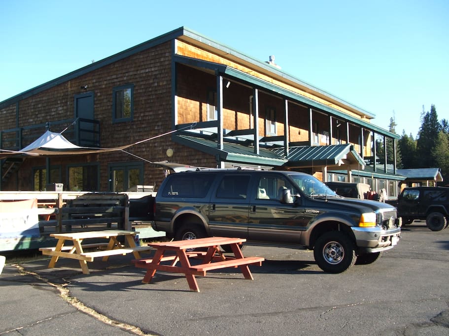 Front view of Tamarack Lodge with back deck and picnic area.