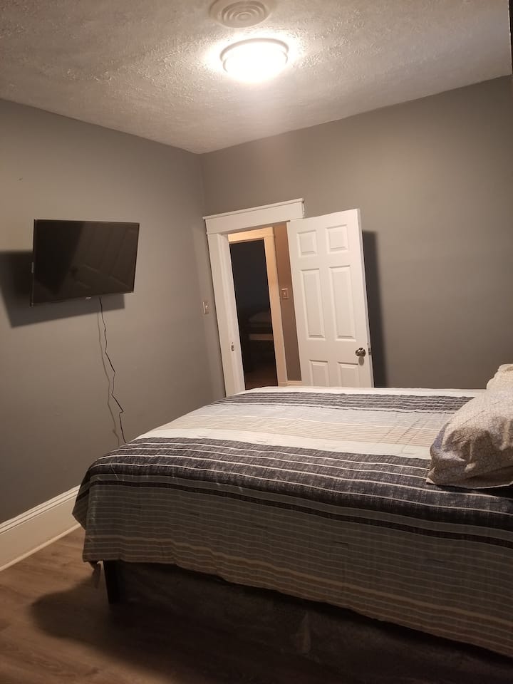 This bedroom have a beautiful recliner chair to relax, Comfy queen size bed, 40" smart Roku tv and large closet with hangers and a fan.