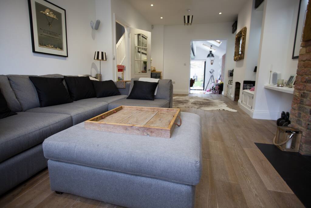 Comfy sofa with surround sound music, wif fi and working fire place with a stone hearth.