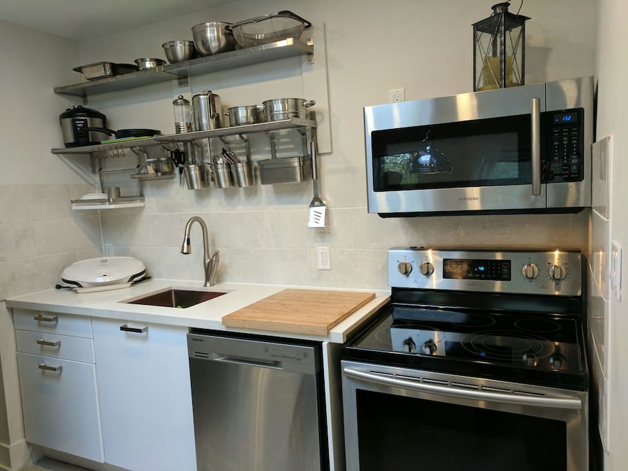 Kitchen: Dishwasher, Microwave, Stove, Stainless Steel.