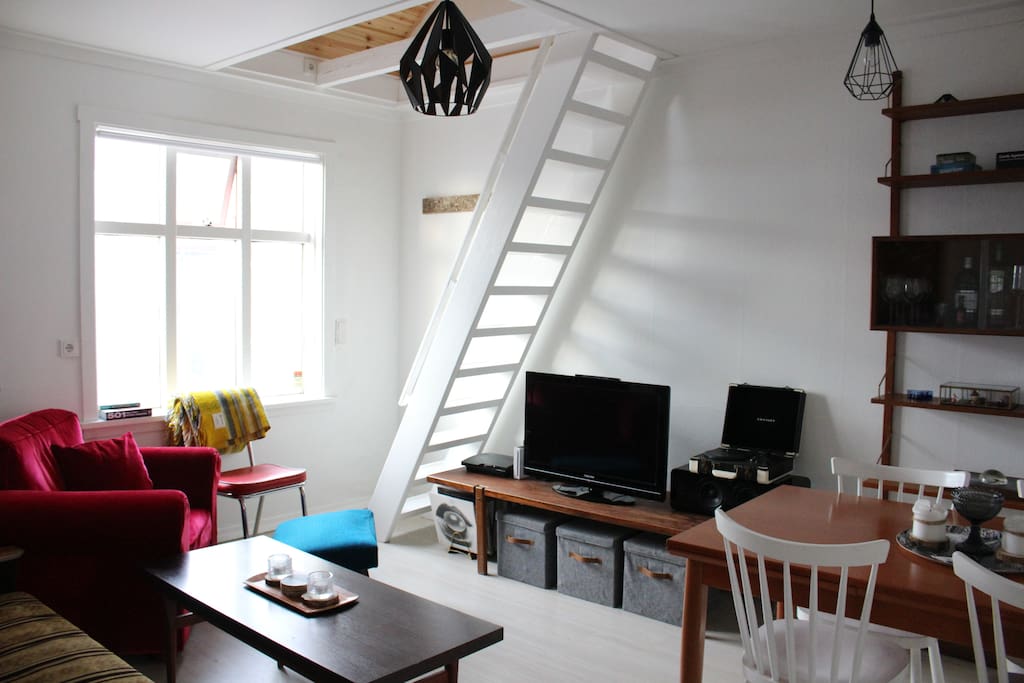 Living room with staircase leading to sleeping loft