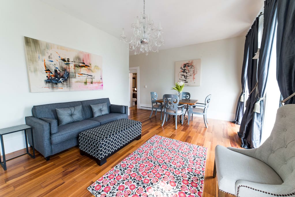 Living room includes a pull out bed that sleeps two. Extra sheets are inside the ottoman.