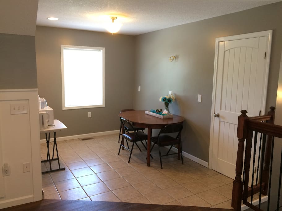 Microwave, fridge, coffee pot, and table