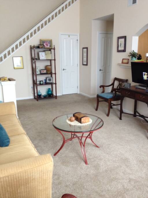 living room with stairs to the loft