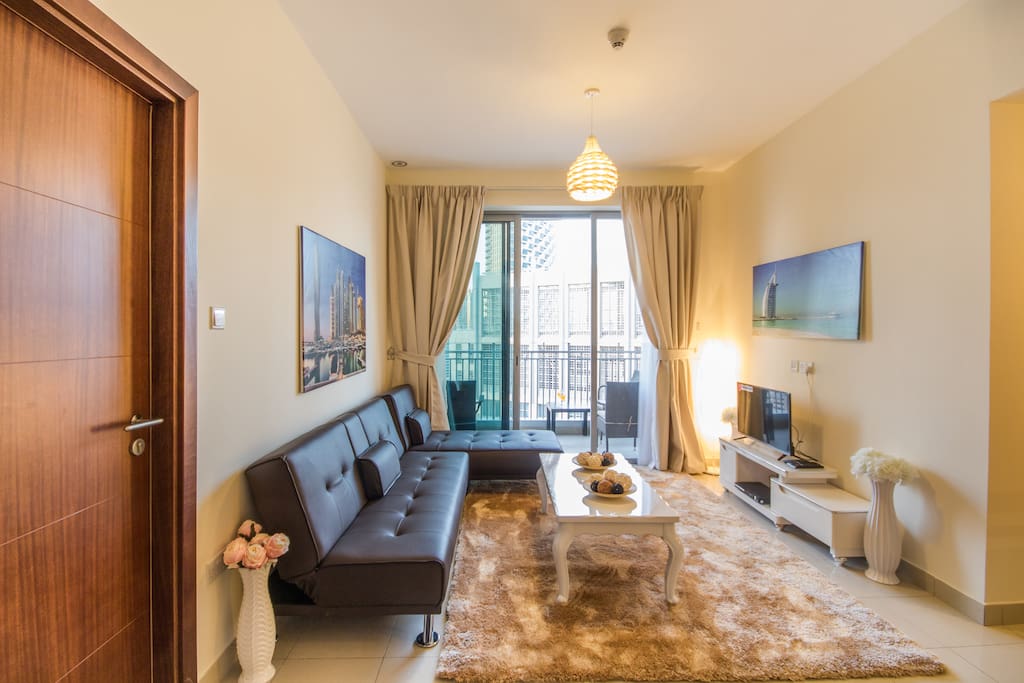 Welcome to Dubai: This living room features a balcony with Burk Khalifa view, a large TV and a comfortable sleep sofa (sleeps 2).