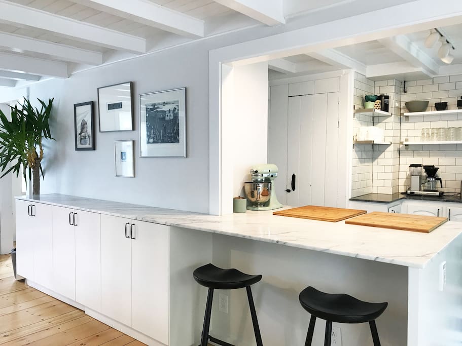 The fully equipped chef's kitchen with a Carrara peninsula, subzero fridge and an externally vented hood.