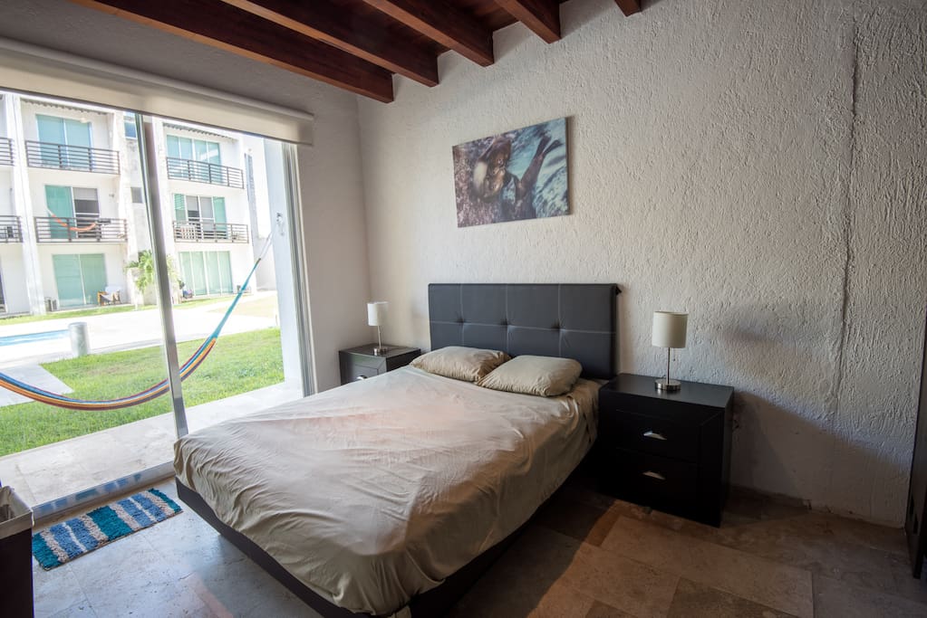 Master Bedroom with private bathroom and easy pool access.