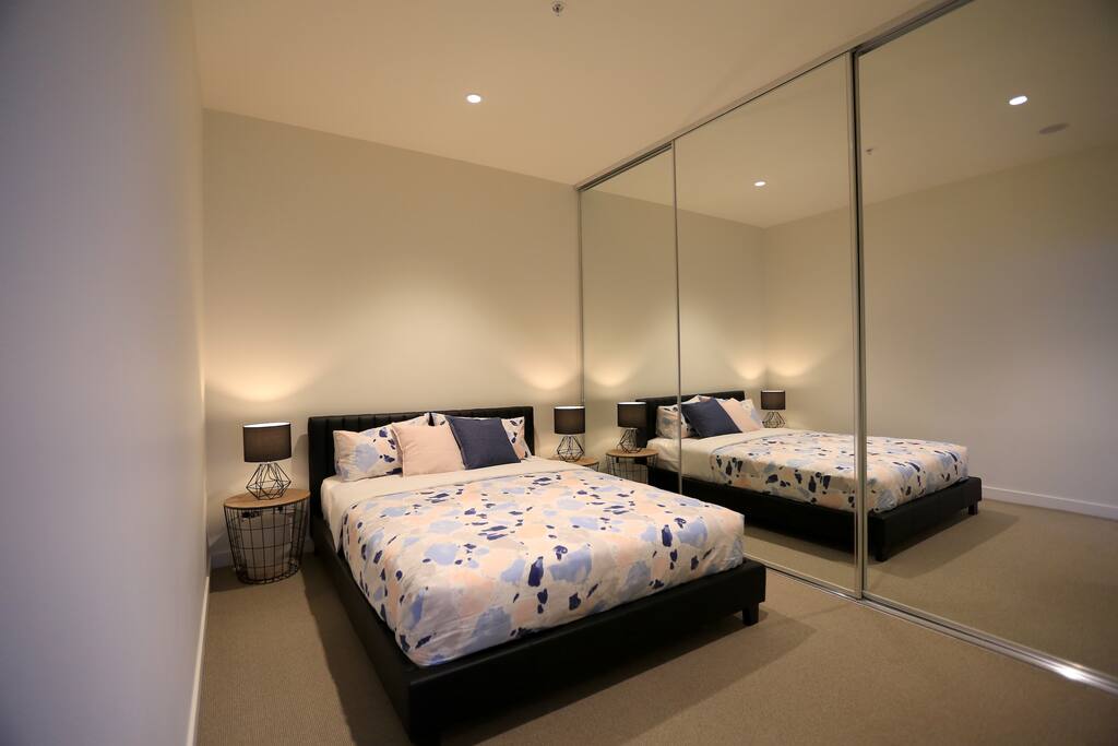 Commodious 1st bedroom with a cosy queen-sized bed.