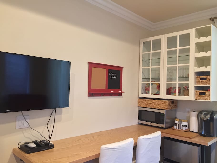 Built in work/eat counter with barstools and kitchenette.