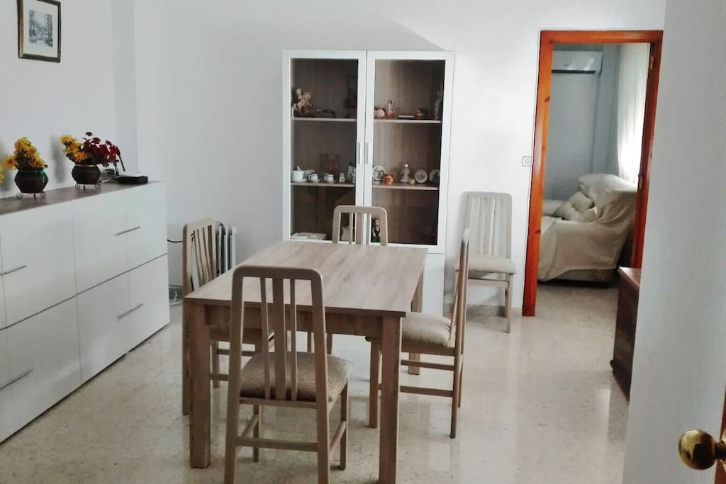 Wide dining room with living room at the back.