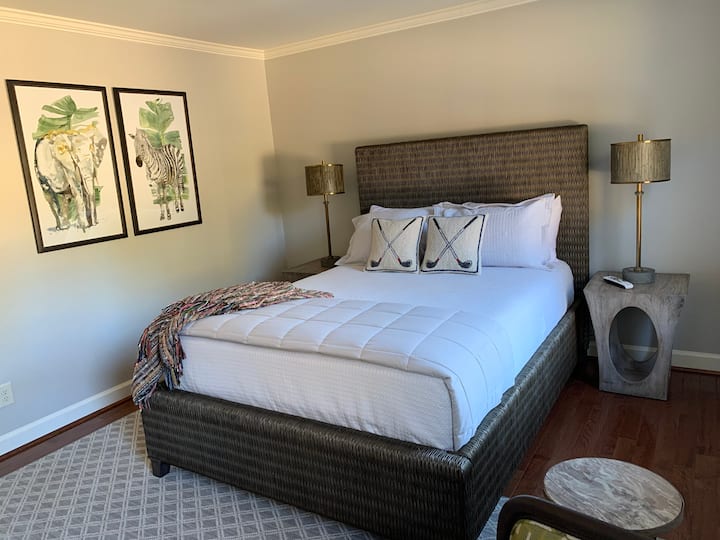 The Dogwood Room is inviting with a plush queen size bed, comfortable seating and a 50in Ultra HD Smart TV on tlit mount. The versatile walk in closet doubles as extra storage space or a changing area. 
