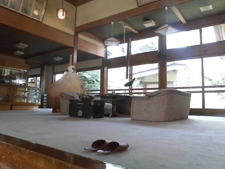 Lobby, with warm wood construction, fireplace, and views of our central garden and koi pond.