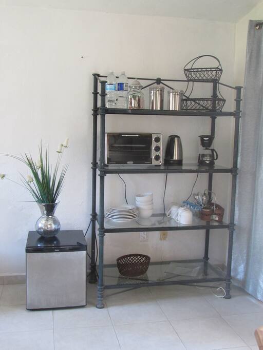 Toaster oven, coffee maker and pot for boiling water. Tea and coffee in room. Mini refri.