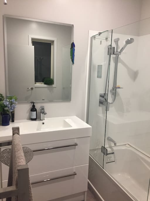 Bathroom. Shower over bath, heated towel rail, toilet and sink