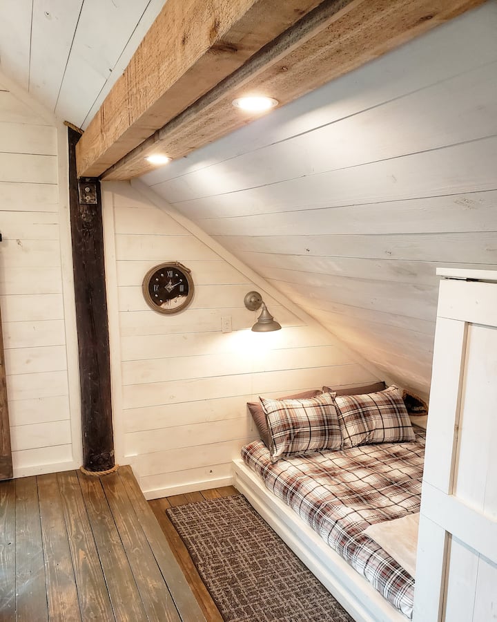 Two cozy queen size beds tucked into the corners of the barn.