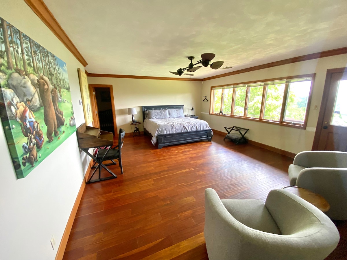 Upper level Master bedroom with walkout balcony and bistro set to enjoy the sunrise.  The nook room behind the bed has a baby crib, rocking chair, and twin bed with nightstand, lamp, luggage rack, USB port, sound machine 