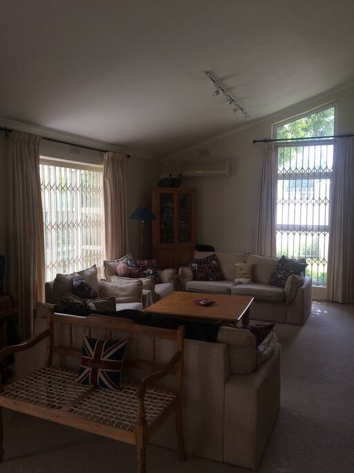 Main reception room with comfy sofas to seat 6 people, and dining table with chairs