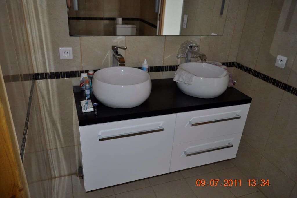 En suite bathroom/shower with twin sinks