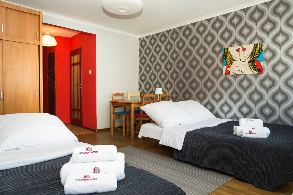 Table for four people and two double beds.
