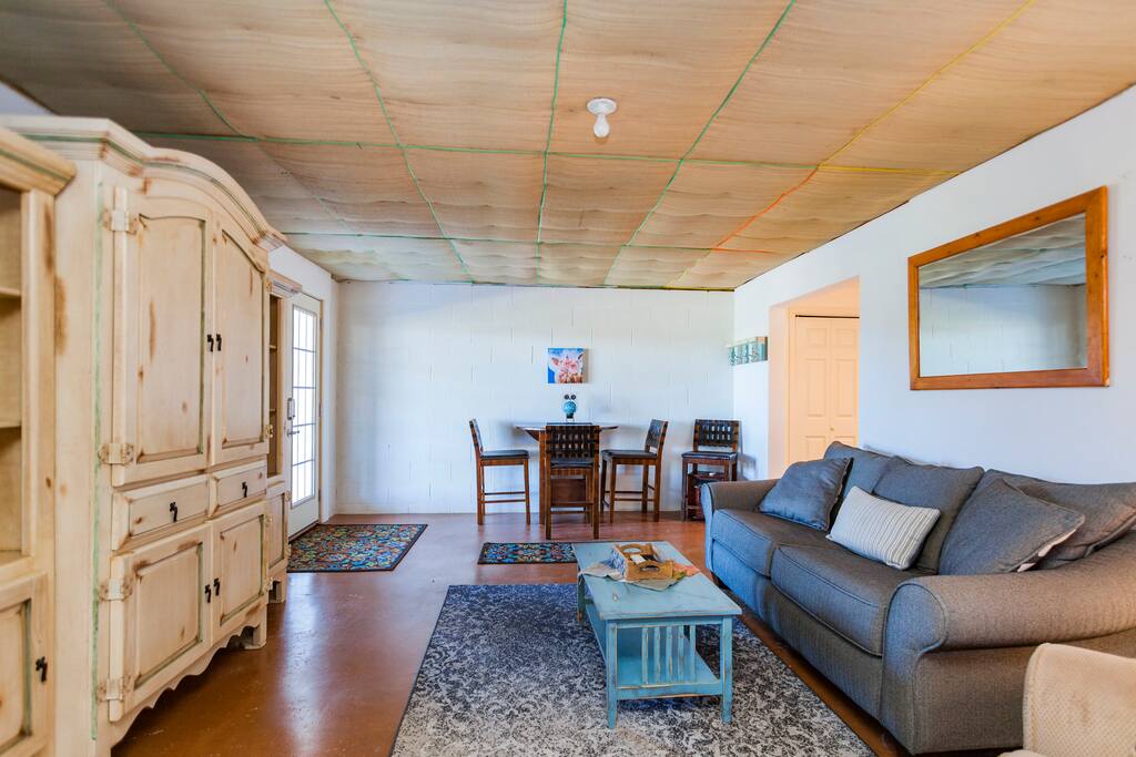 Living room, sofa sleeper queen size, high top table with four chairs, flat screen tv in armoire.