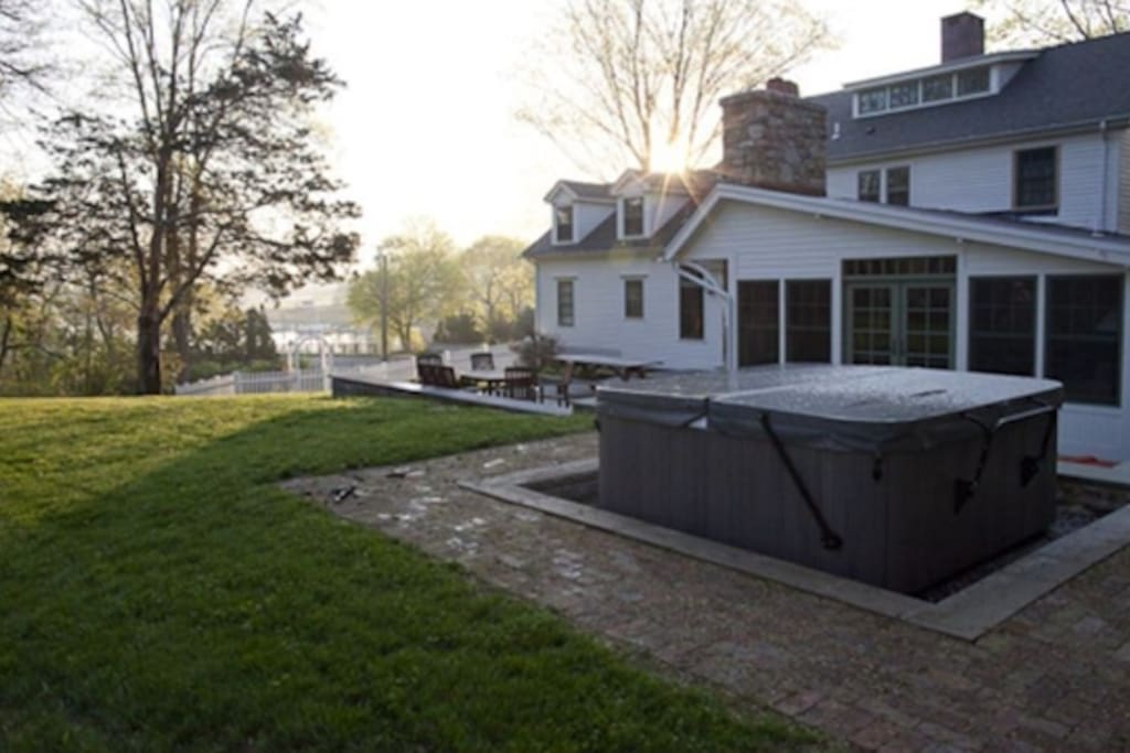 view of the backyard and hot tub.