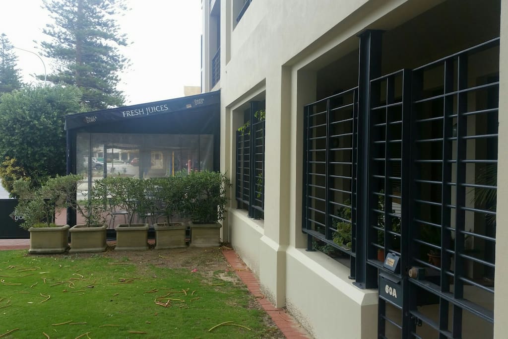 Front of building, with café next door.