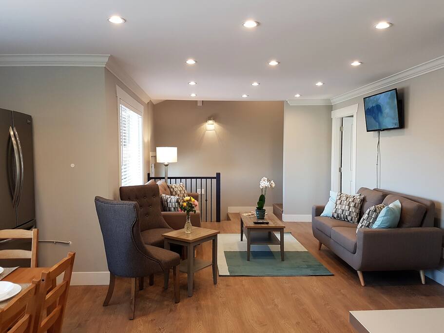 Spacious living-room with comfortable sofas to relax and watch TV after an exhausting day .