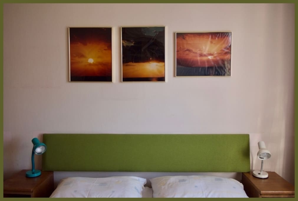 Larger bedroom with double bed and my grandfather's photography