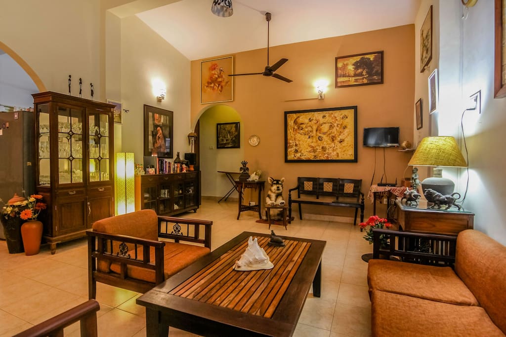 the living room seating space ,with traditional / antique furniture , paintings , and art pieces...