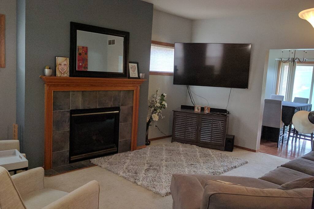 Living room - 70' TV - Gas Fire Place, Dining room with seating for eight.