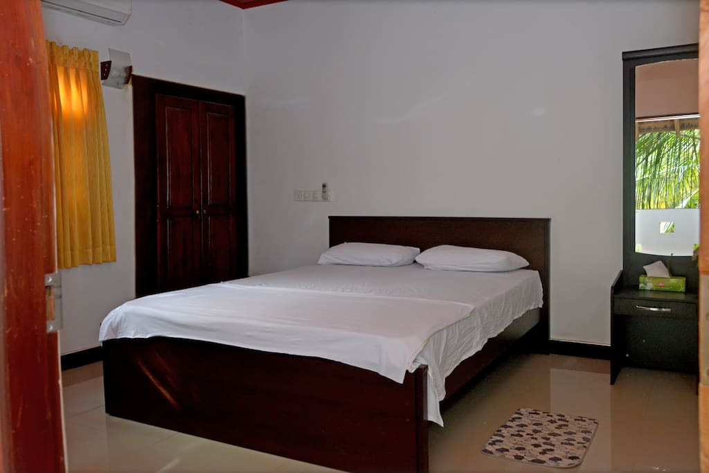 Master bedroom with wardrobe, mirror, vanity unit and attached bathroom
