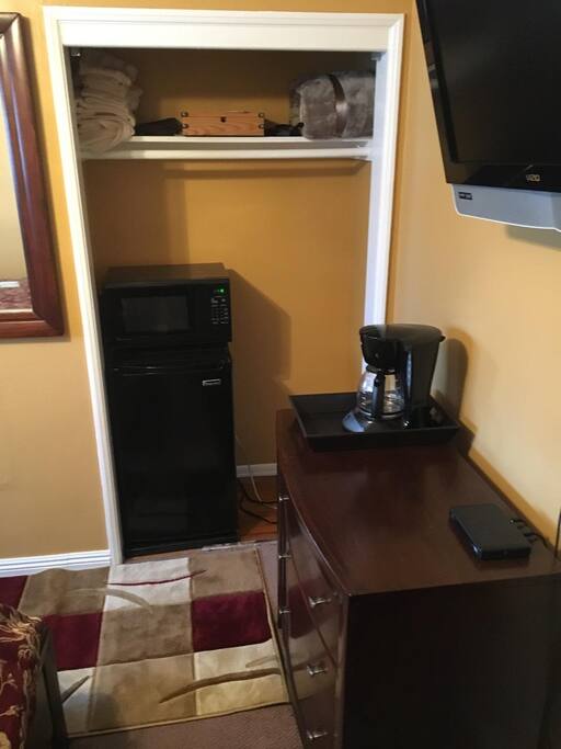 Closet, microwave and mini fridge