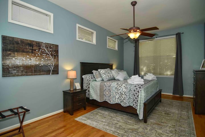 The spacious master bedroom has a king bed with a pillow-top mattress and room darkening curtains