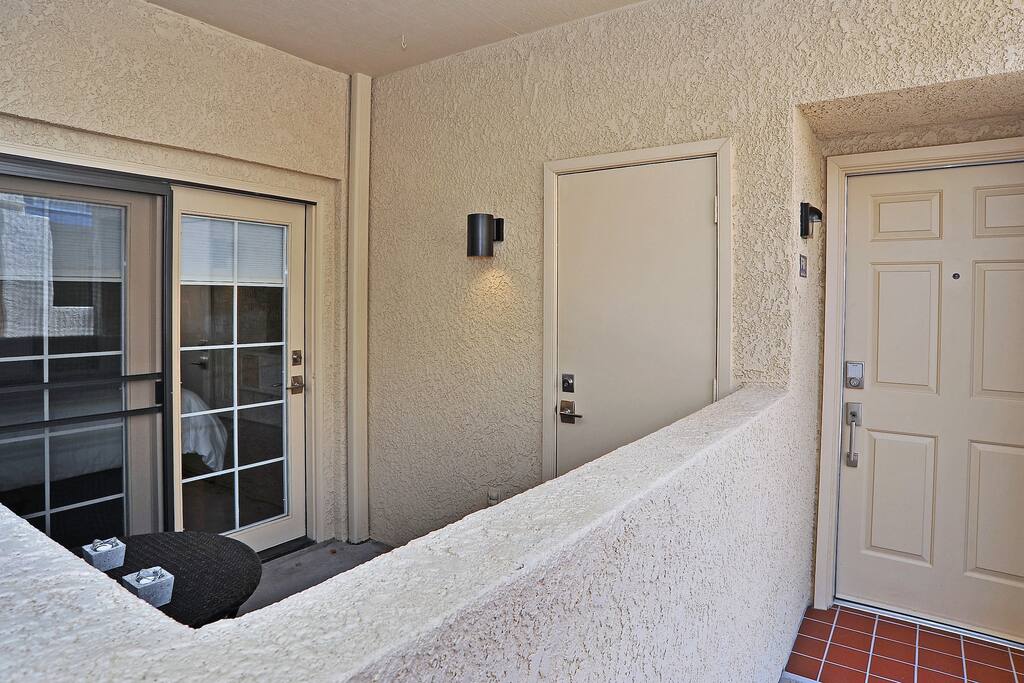 Lit entrance and private patio area.