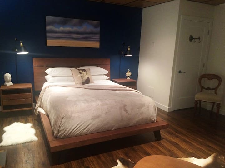 Your bed is a very comfy, hypoallergenic, no-scent, or perfumed softener used. Sealy feather top mattress with high thread count sheets that are soft not stiff. Bose speaker access & a phone charging station.  Ian Sheldon art is displayed throughout.