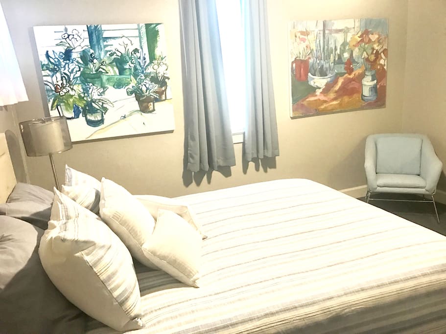 Queen Bedroom #1. Clean & Cozy. Beautiful art pieces & lots of pillows! Enjoy a restful nights sleep! New bedding and art work.