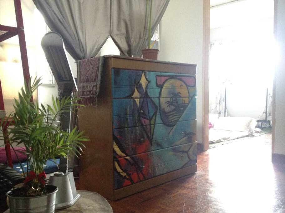 Dresser to keep bedsheets and various house items. Artwork by 321