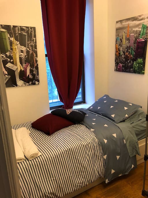 Second bedroom features twin size bed with linens and towels