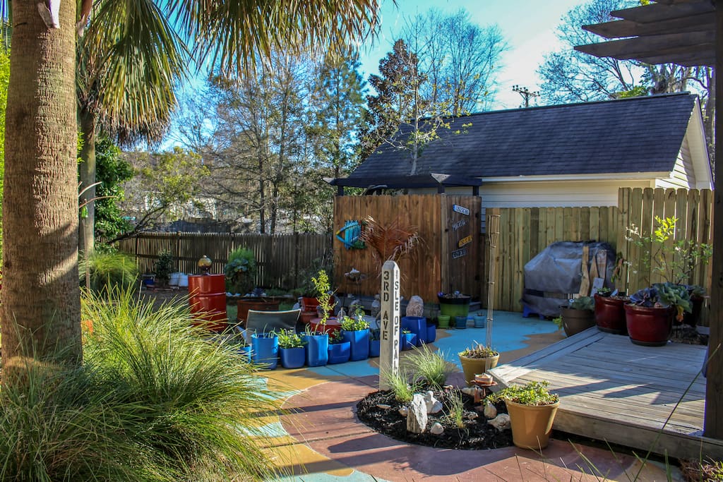 View of back as you walk around the drive. Fire pit and outdoor spa.