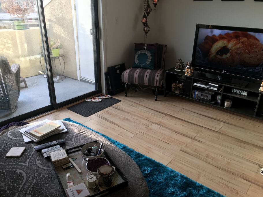 Living room with 42" TV and DVD player. Balcony with views of downtown San Jose.
